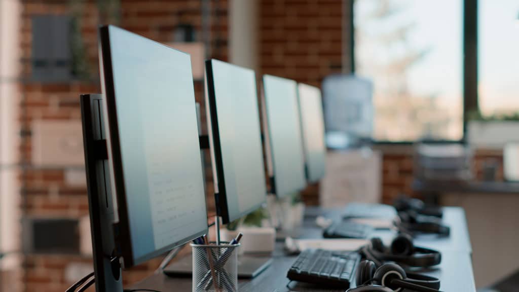 Nobody at customer care workstation with multiple computers