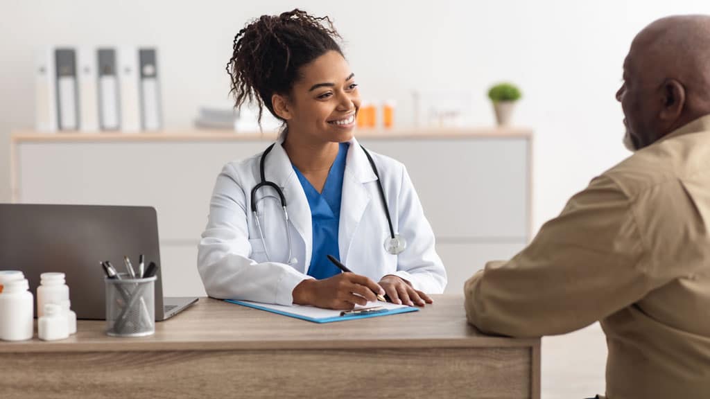 Young black doctor explaining treatment plan to male patient